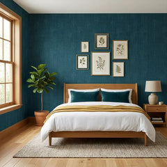 Close-up botanical motif on linen-textured wallpaper, delicate leaf and branch pattern