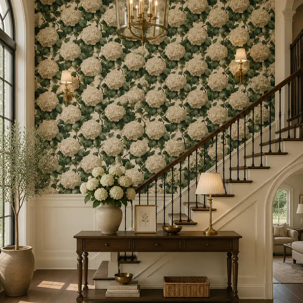 Grand staircase foyer accented with ivory hydrangea wallpaper and warm interior lighting