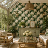 Bright sunroom with rattan furniture surrounded by ivory hydrangea wallpaper accents