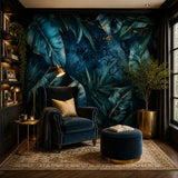 Navy palm leaf wallpaper in a reading corner with velvet armchair and ottoman