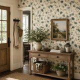 Entryway console table near front door framed by watercolor eucalyptus wallpaper