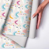Beautiful pastel rainbow and cloud kids room nursery wallpaper adds harmony.