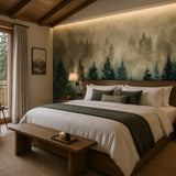 Misty forest mural above a bed in a cozy cabin bedroom with wood ceiling beams