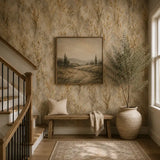 Staircase entryway bench framed by golden wild meadow wallpaper and warm decor