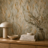 Golden wild meadow wallpaper styled behind a sideboard with lamp and books
