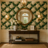 Elegant entryway with a round mirror and console table framed by ivory hydrangea wallpaper