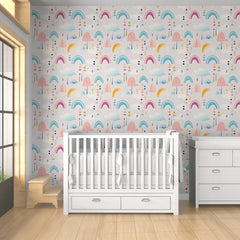Pastel rainbow and cloud kids room nursery wallpaper creates a calm dreamy feel.